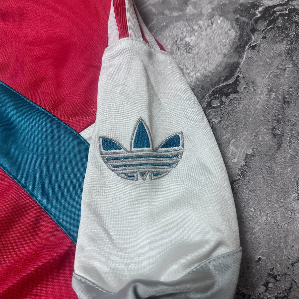 Broderie logo trèfle Adidas bleu sur la manche gauche